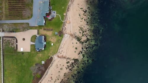 An aerial, top down view of the waterfront properties and beach of the Long Island Sound in Greenpor