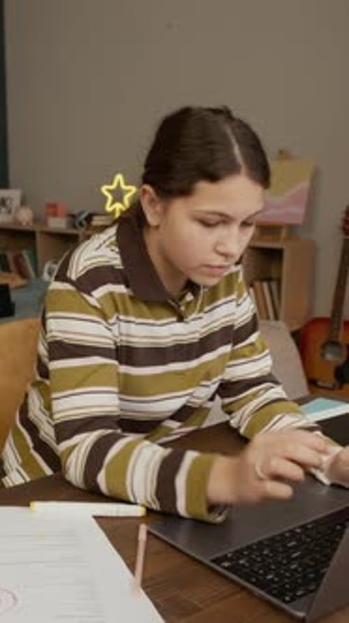 Teenage Girl Studying at Desk with Laptop Indoors