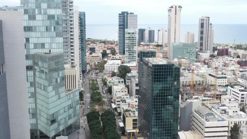 Aerial Shot Of Downtown District In Residential City, Drone Flying Forward Over Cars Moving On Road