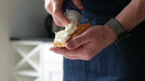 Chef Adding A Topping Whipped Cream On A Belgium Waffle Close Up