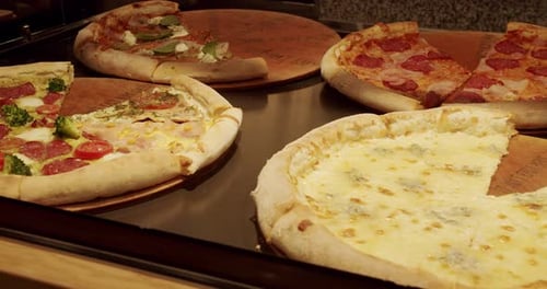 Lots of Pizza Slice on the Table in a Pizzeria Delicious Pizza