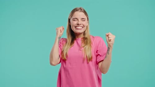Excited Woman Celebrates Success on a Blue Background