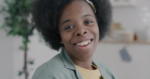 Smiling Woman with Curly Hair Close-Up Portrait