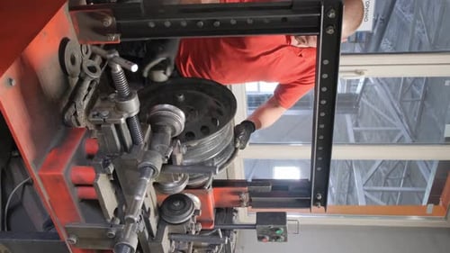 Portrait of a Mechanic Repairing Car Wheels Car Service Vertical Video