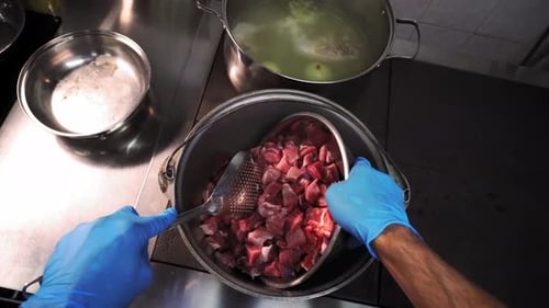 Chef Preparing Diced Meat for Cooking in Restaurant