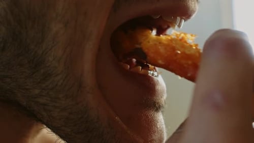 Man Eating Crunchy Snack Food Close-Up