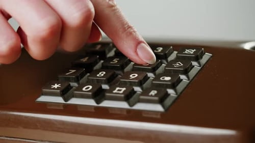 Hand Holding Old and Retro Telephone Vintage Phone Headset Isolated on Grey Studio Background Woman