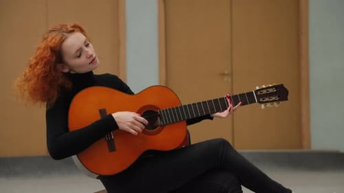 Woman Playing Acoustic Guitar Indoors