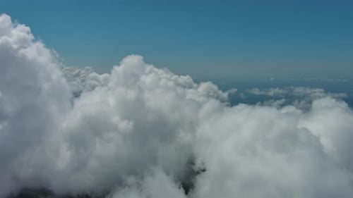 Flying Through White Clouds Over Sea