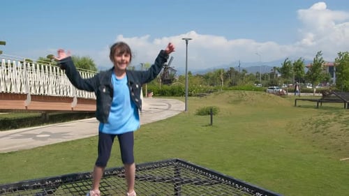 Child on Trampoline on Beach