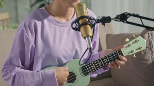 Asian Girl Playing Ukulele and Singing at Home Music Studio