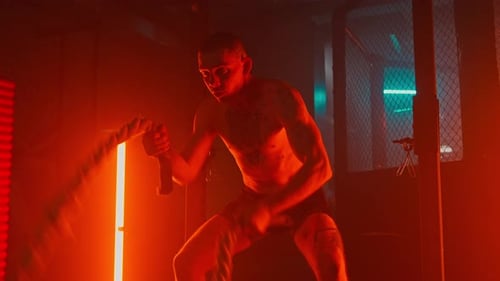 Muscular Man Doing Rope Training at Gym