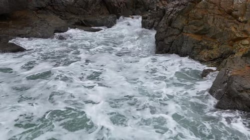 Dynamic Ocean Waves Crashing on Black Stones with Strong Motion