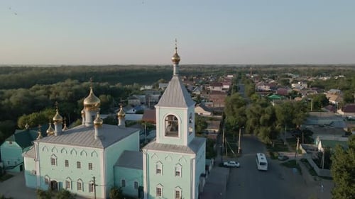 Bell Tower of Church with Christian Cross on Background of Clear Sky