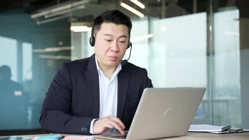 Professional Man Engaged in Video Call at Office