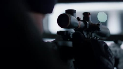 Closeup Hired Sniper Preparing to Shoot with Automatic Rifle. Male Soldier Loading