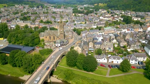 Aerial Drone shot flying from the Tweed Bridge towards Peebles Old Parish Church in the town of Peeb