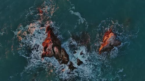Top View of Waves and Rocks in Sea