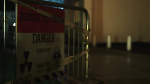 Danger, restricted access biohazard sign at night.