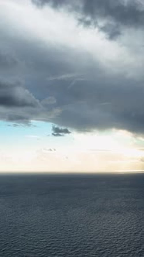 Vertical Video Coastal Euphoria Aerial View of the Enchanting Cloudy Sunset Over the Mediterranean