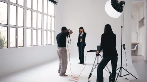 Model Posing for Photos in Bright Studio