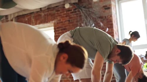 Fitness, Sport and Healthy Lifestyle Concept - Group of People Making Yoga