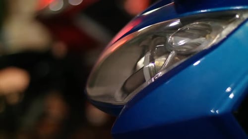 Motorcycle turn signal lights in blue with background blur