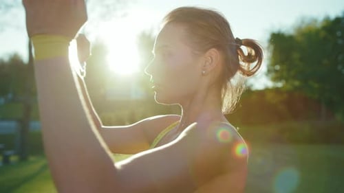 Young Woman Exercising with Resistance Band Outdoors