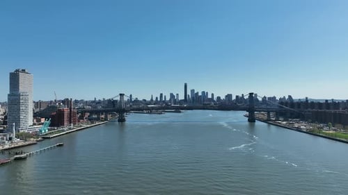Historic Williamsburg suspension bridge over East River with Downtown Brooklyn Skylines cityscape in