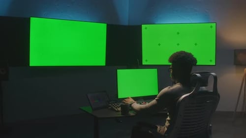 Un homme travaille sur ordinateur en studio avec du matériel