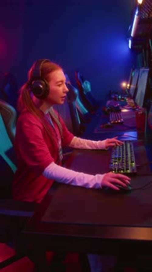 Young Woman Playing Computer Games in an Esports Arena