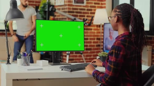 Woman Typing at Computer with Green Screen