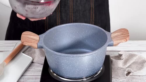 Woman Prepares Fruit Preserves in Kitchen at Home