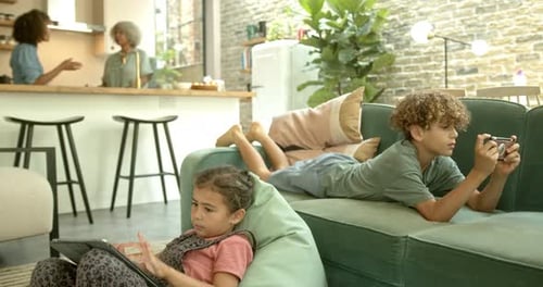 Children Relaxing with Devices at Home