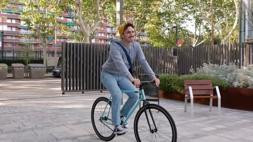 Young Adult Hipster Man Commuting to Work with His Bicycle