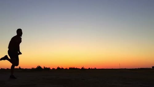 Man Running in Silhouette at Sunset