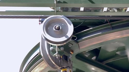 Close up on sheave wheel holding rope of gondola mechanism