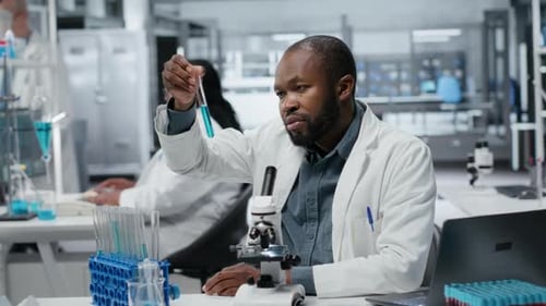 Spécialiste du développement d'essais en laboratoire étudiant un polymère liquide bleu