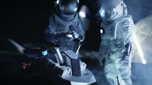 Astronauts on Lunar Surface Examine Equipment at Night