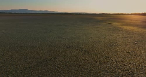 Cracked Earth Landscape at Sunrise