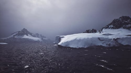 Dramatic Snowy Mountain Landscape with Choppy Water