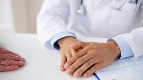 Doctor hands support senior woman patient in hospital healthcare concept