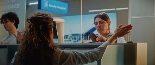 Multiethnic Passengers at Airport Checkin Counter Female Airline Worker Checking Documents