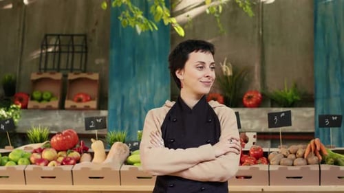 Caucasian Vendor Standing with Amrs Crossed at Farmers Market Stand
