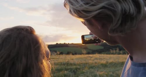 Couple, bonding or phone photography of sunset in travel location, honeymoon date vacation