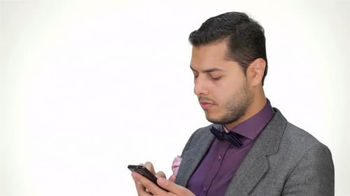 Confident Young Businessman Engrossed in Mobile Phone