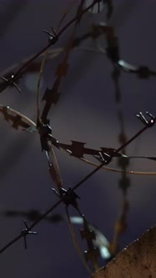 Barbed Wire Fence Details Against of the Night Dramatic Sky Footage Close Up of Concrete Fence with