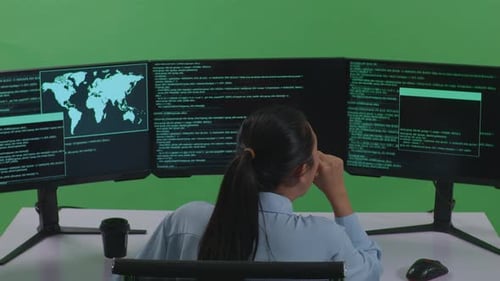 Tired Asian Woman Developer Yawning While Write Code With Multiple Computer Screens In Green Screen
