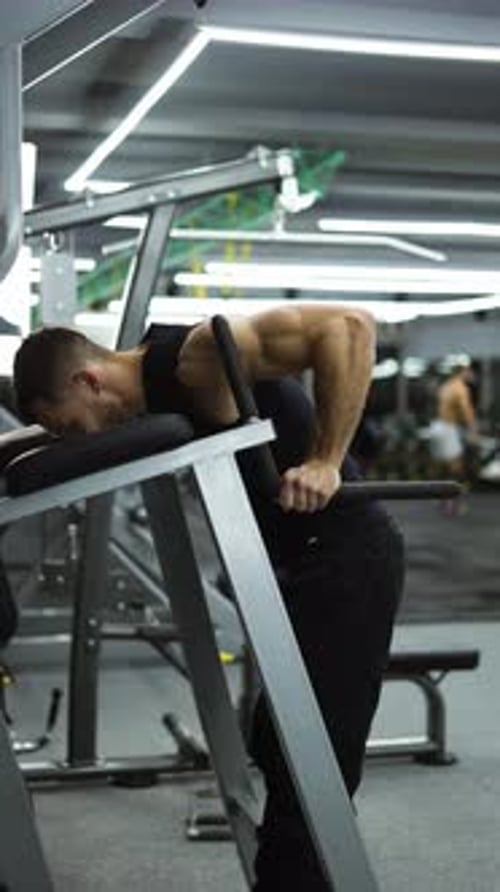 Athlete Man Training Force Push Up and Pull Up Exercise on Bars in Gym