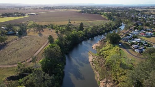 Rural Landscape On The Banks Of Richmond River In Lismore City, NSW, Australia. aerial pullback shot